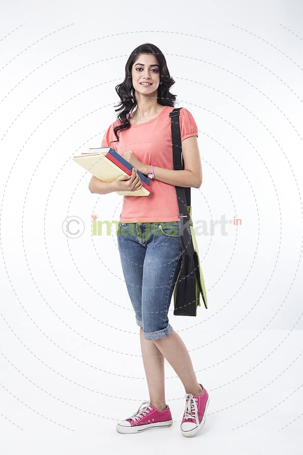 college girl posing with textbooks 