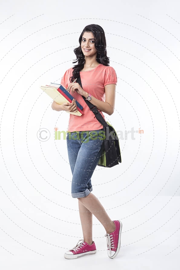college girl posing with textbooks 