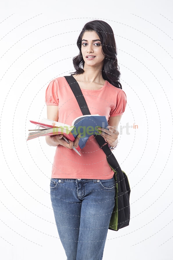 college girl posing while holding a text book