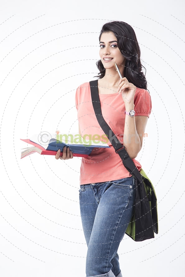 college girl posing while holding a text book