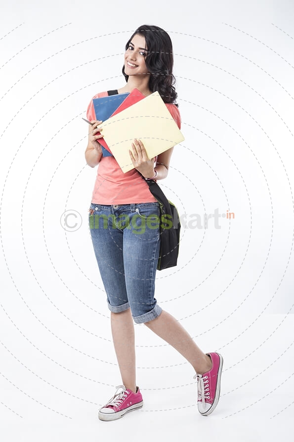 college girl posing with textbooks 