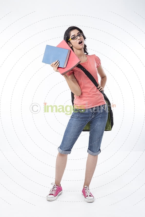 college girl holding text books and posing