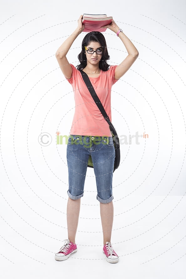 college girl posing with text books 