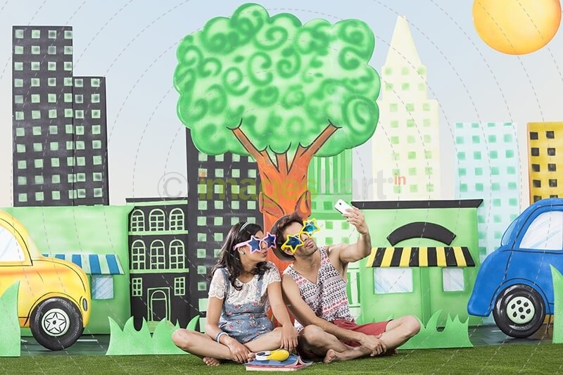 couple in garden taking selfie with mobile phone