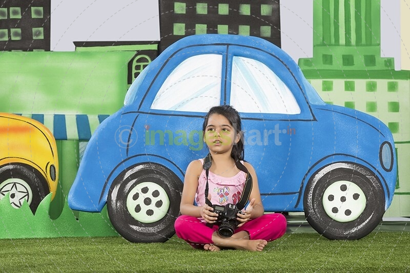 young girl clicking a photograph from camera in the park