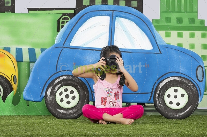 young girl clicking a photograph from camera in the park