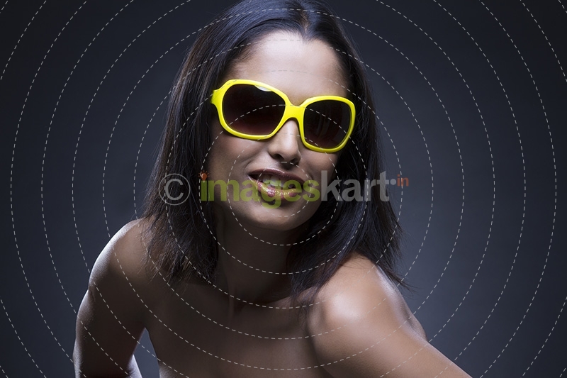 Young girl posing with sunglasses