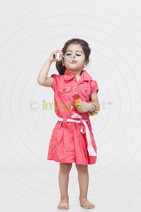 Little girl playing with bubble toy