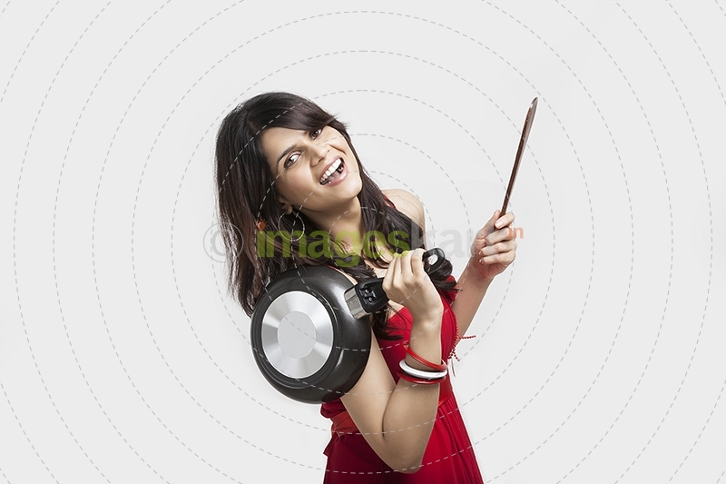 Girl posing with pan and wodden spoon