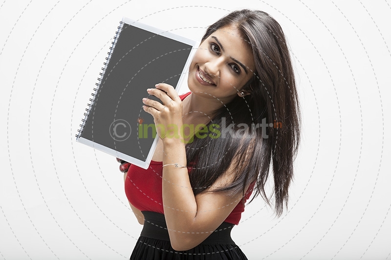 girl posing while holding a text book