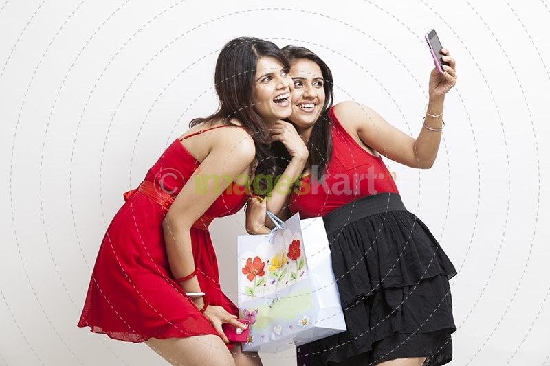 two girls taking selfie on phone