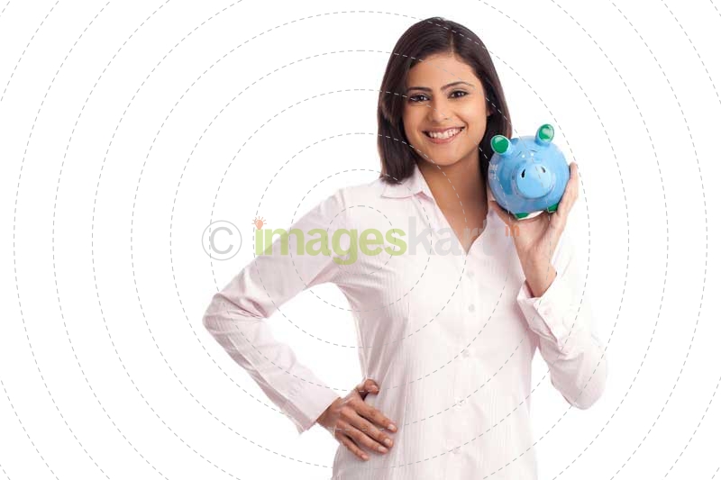 woman in a pink shirt posing with a blue piggy bank