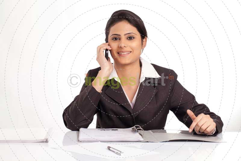 woman looking at the camera and talking on the phone