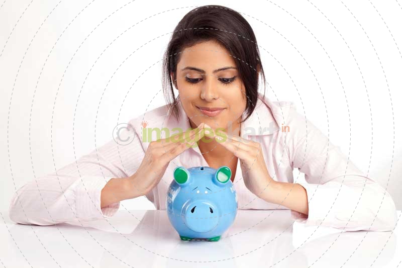 woman in a pink shirt with a blue piggy bank