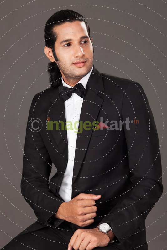 business executive posing while sitting on chair