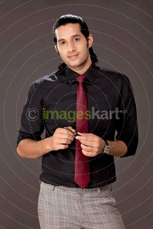 young businessman posing for the camera holding a pen 