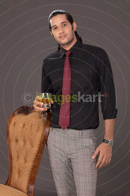 man standing with drink in his hand