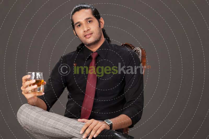 man drinking and looking at the camera 