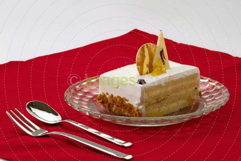 a piece of vanilla cake on a red cloth