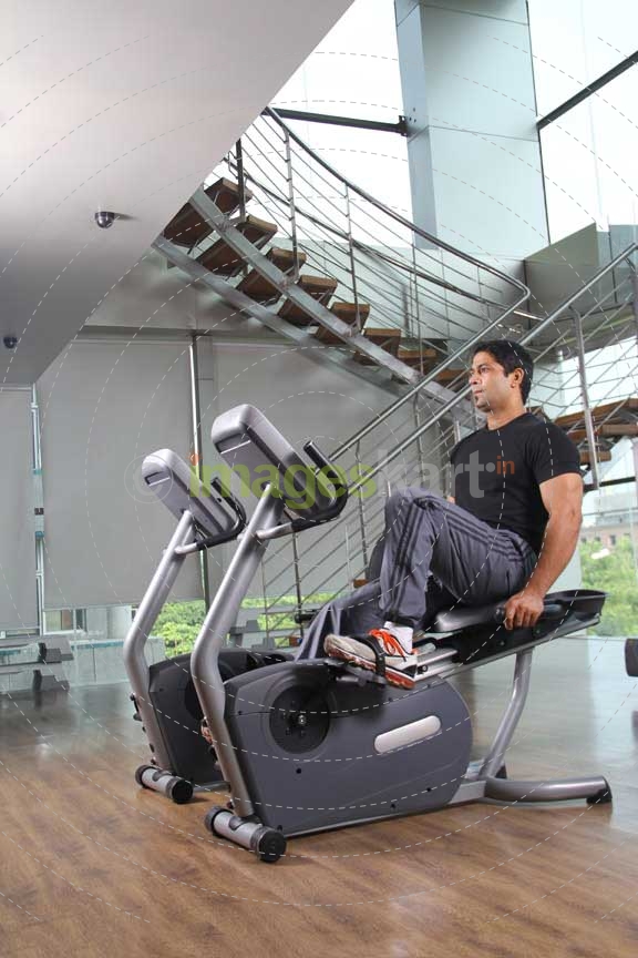 man doing cycling at the gym