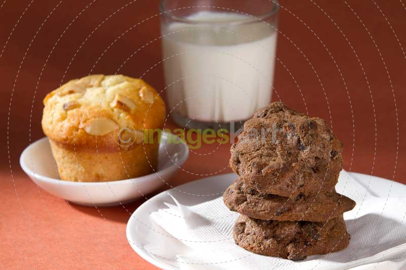 chocolate cookies with muffins and milk