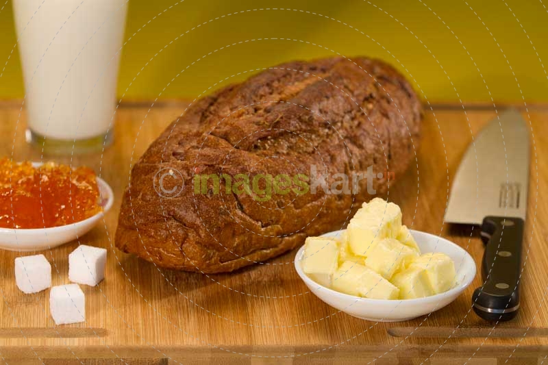 fresh brown bread with butter and jelly