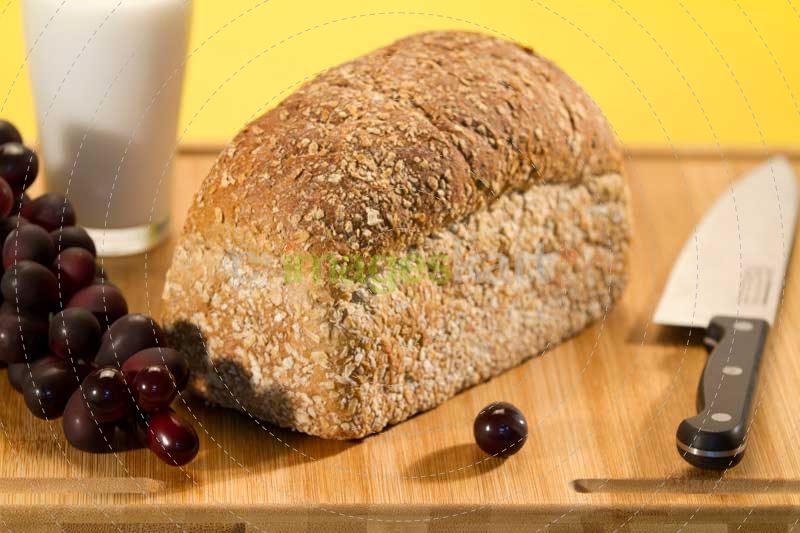fresh brown bread with glass of milk and fruits