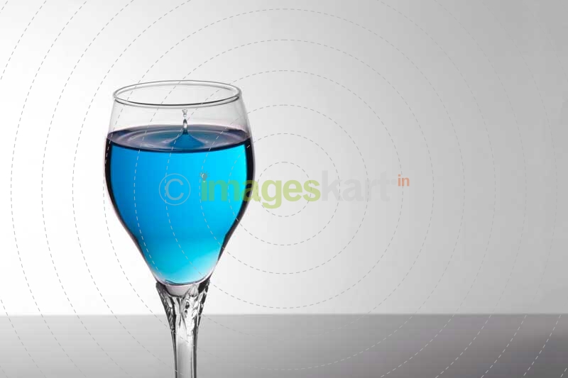 glass of blue mocktail on white background