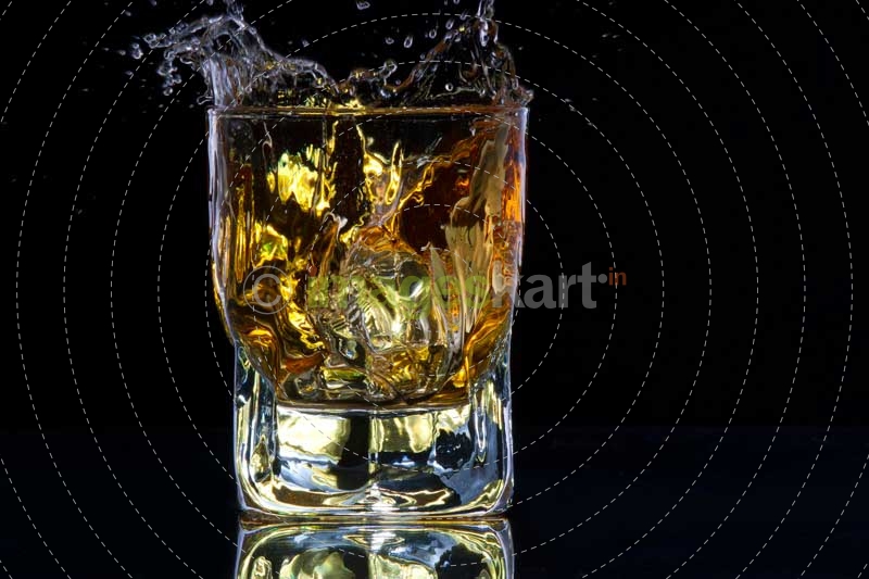 whiskey splashing from a glass of whiskey