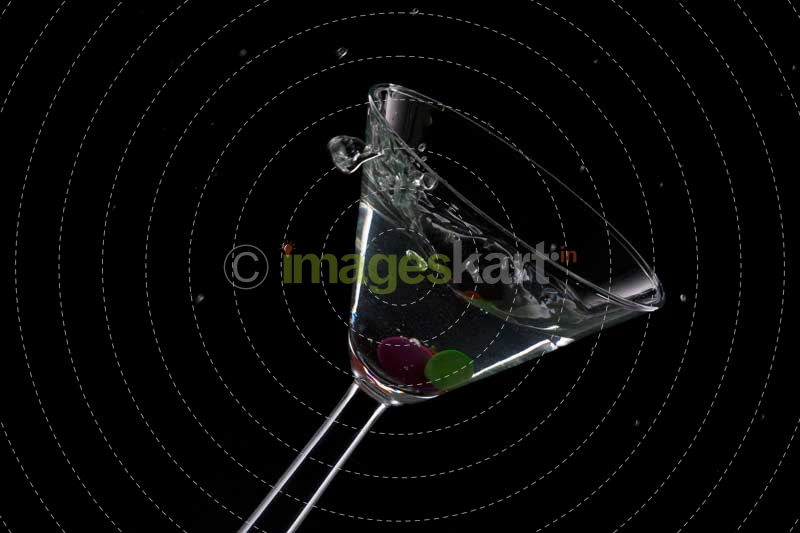 glass of drink stuffed with olive and cherry