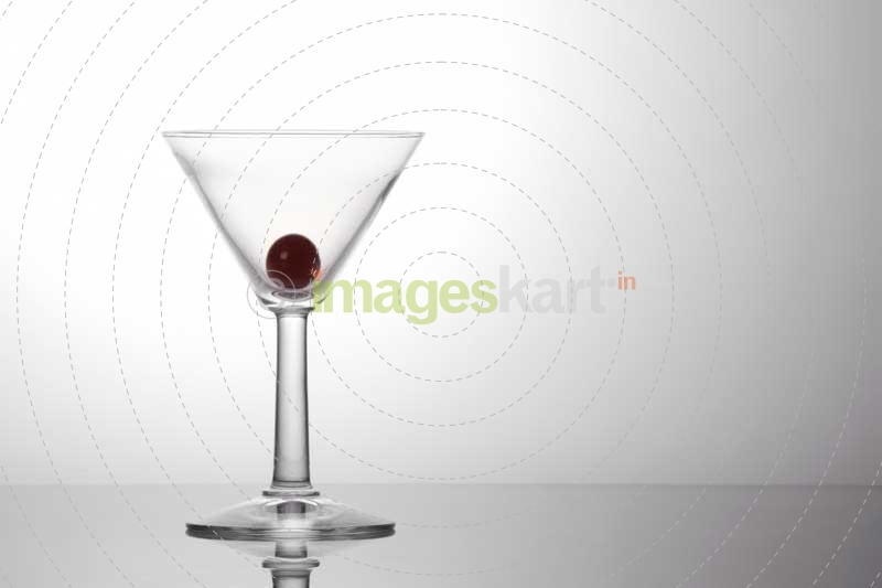 a piece of fresh grape in a cocktail glass