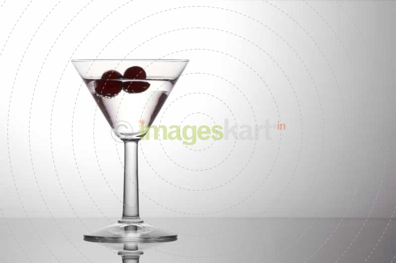 alcohol in a cocktail glass with cherries