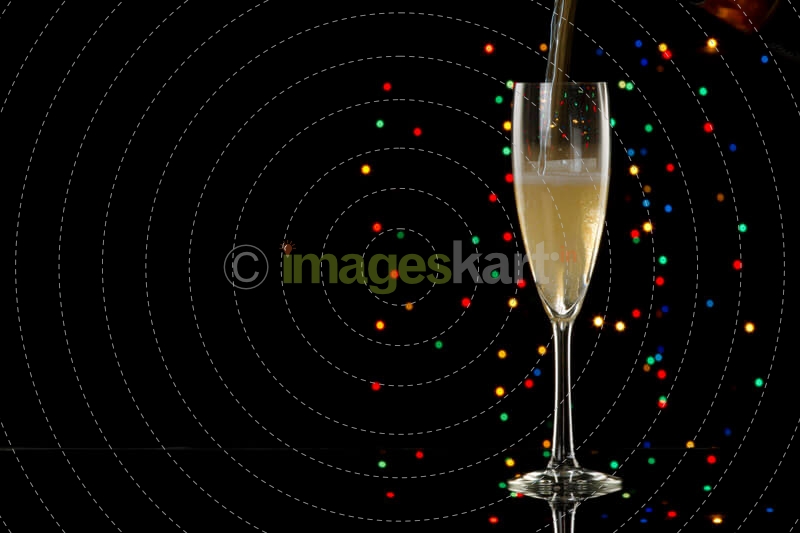 pouring champagne into glass with black background