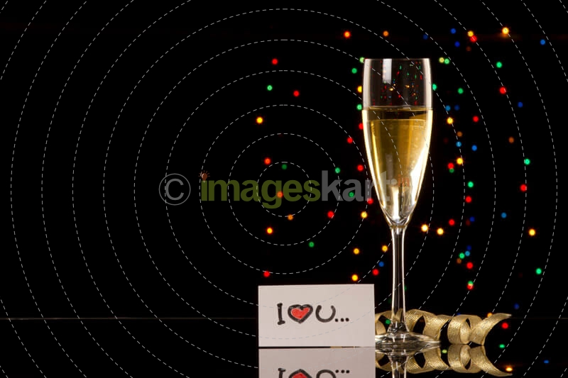 a picture of a glass of champagne with love note on dark background