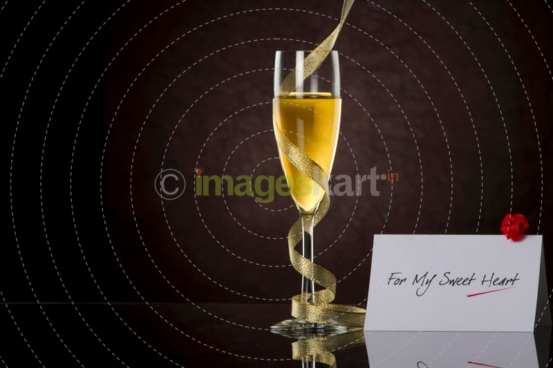 champagne glass with black background and note
