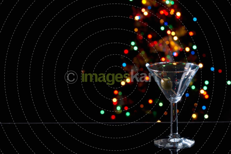 an empty martini glass with olive in it