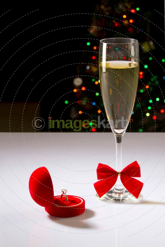 a wedding ring and wine full glass describing the moment of love 