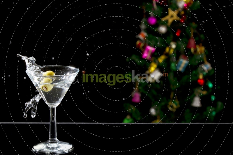 a martini drink with olives in motion