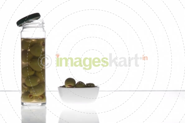 olives in a jar and  a bowl