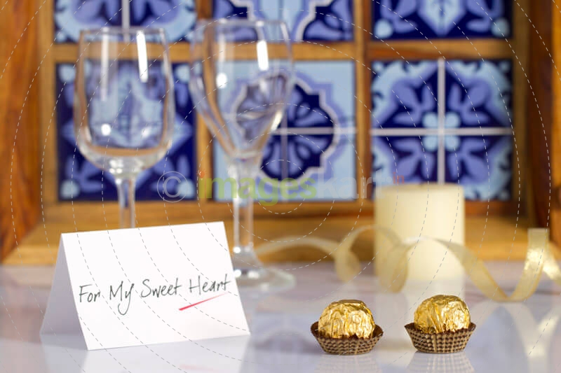 wine glasses and chocolates with love note