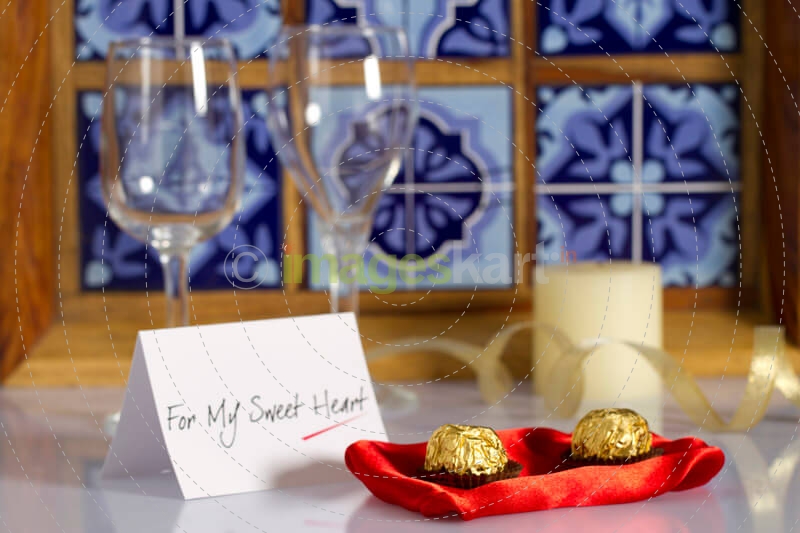 chocolate balls and a note on the table with champagne glasses