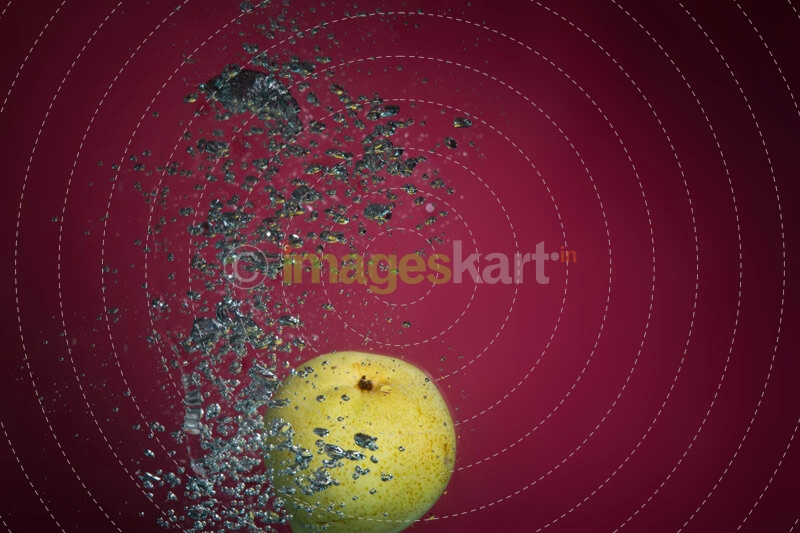 fresh pear falling into clean water