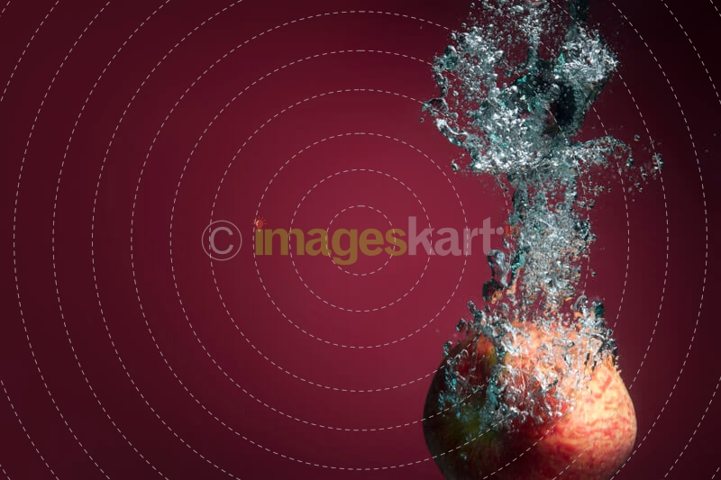 apple sinking in water and forming water waves