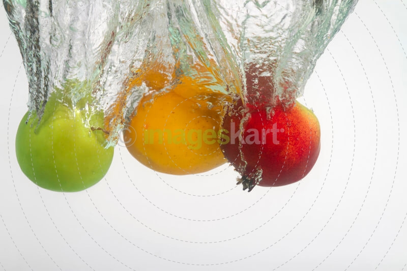 three multicoloured fruits in water