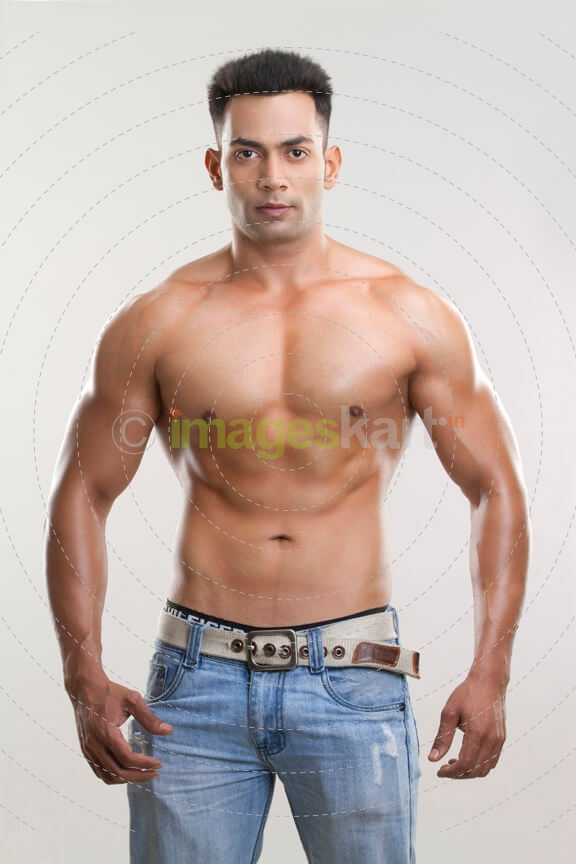 man posing shirtless in his jeans