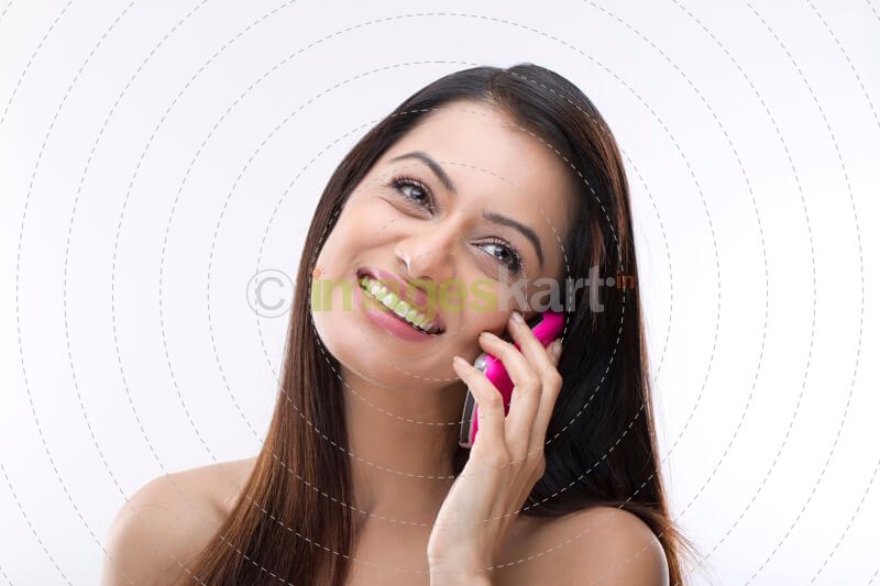 female smiling over the phone against a white background
