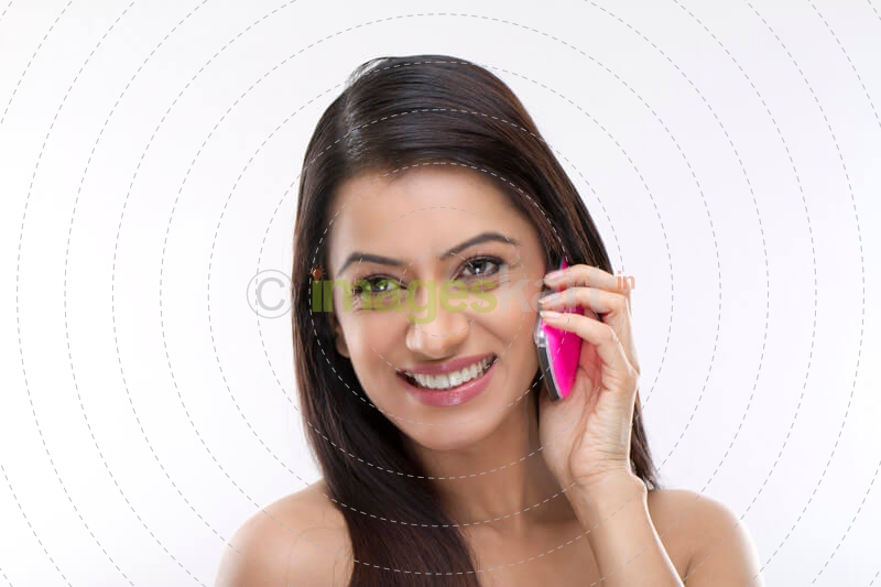 portrait of a smiling girl talking on the phone