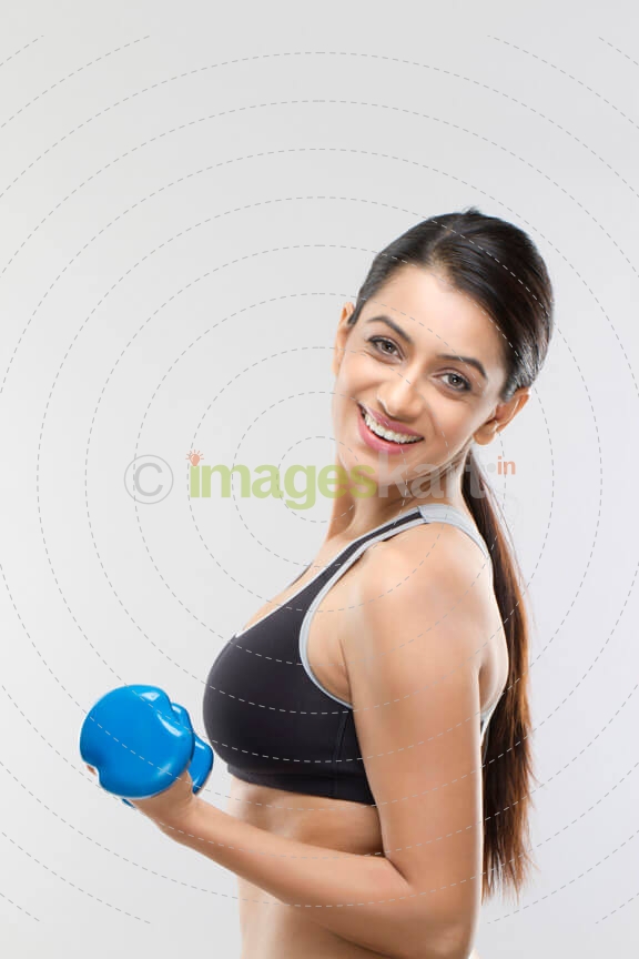 attractive girl lifting dumbbells