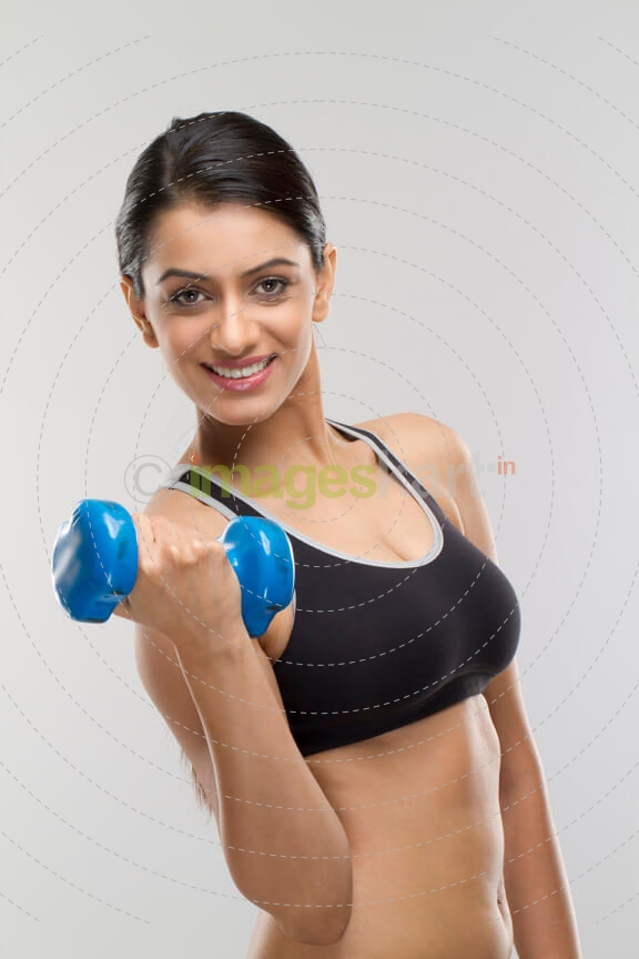 attractive girl lifting dumbbells