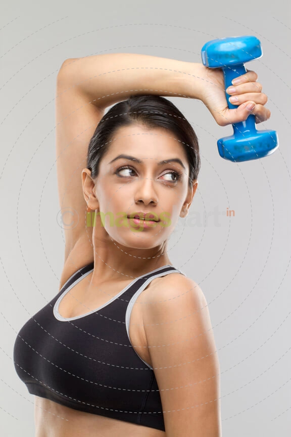 young female lifting a blue coloured dumbbell